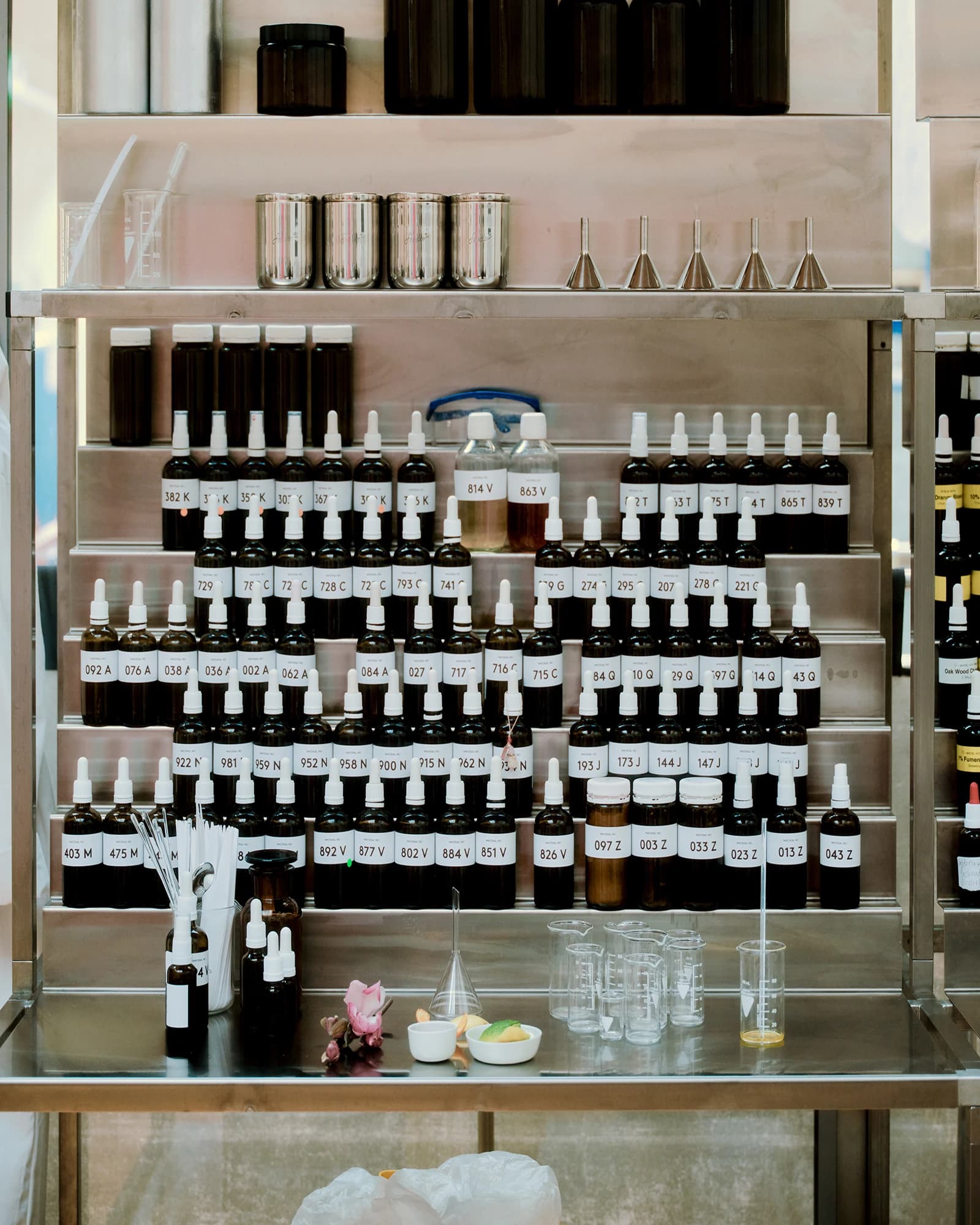 A shelf with numbered brown vials containing fragrances in a laboratory