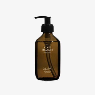 Savon pour les mains Soeder « Vivid Bloom » 250 ml, dans un flacon en verre marron muni d'une pompe noire, sur fond gris clair